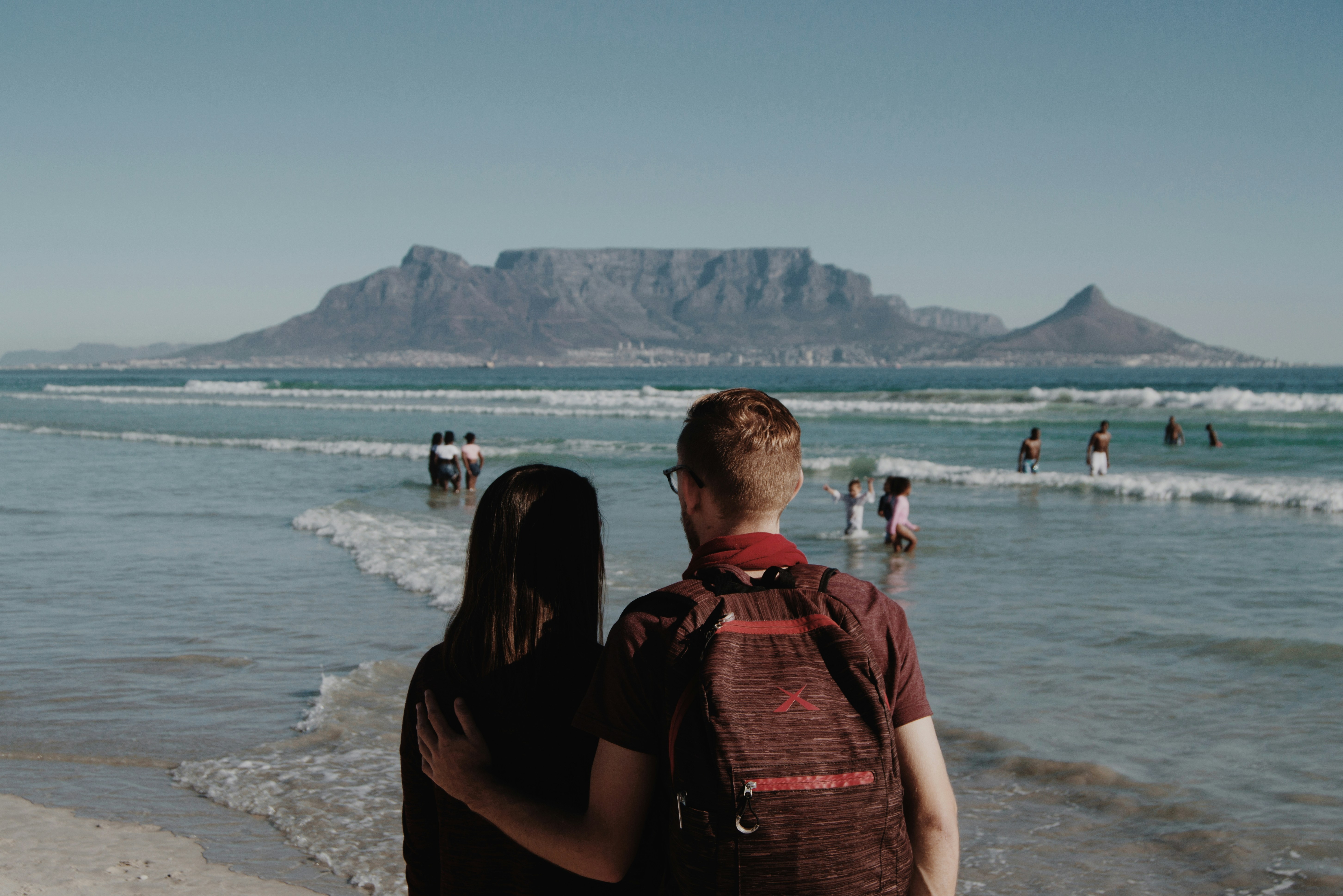 A couple taking in the beauty of the ocean-mountain view